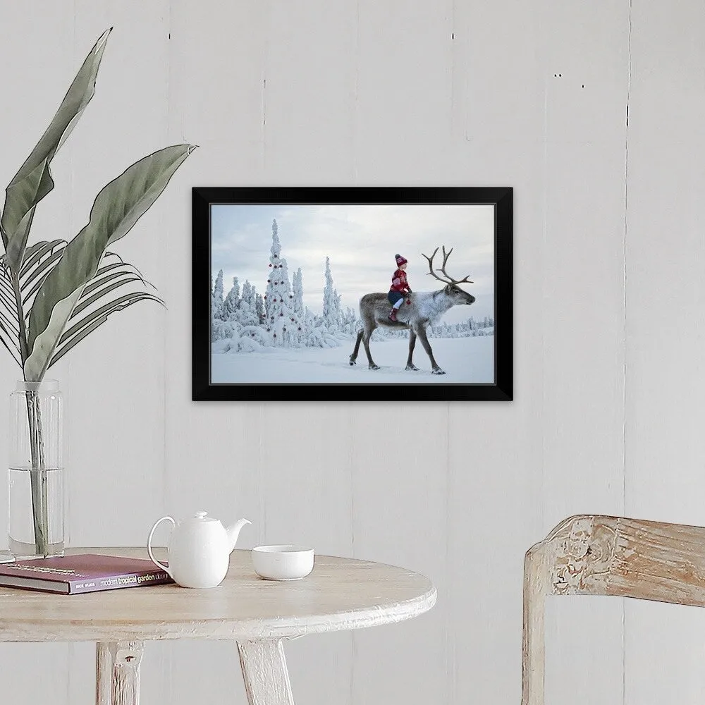 "A girl riding a reindeer through a winter forest" Black Framed Print