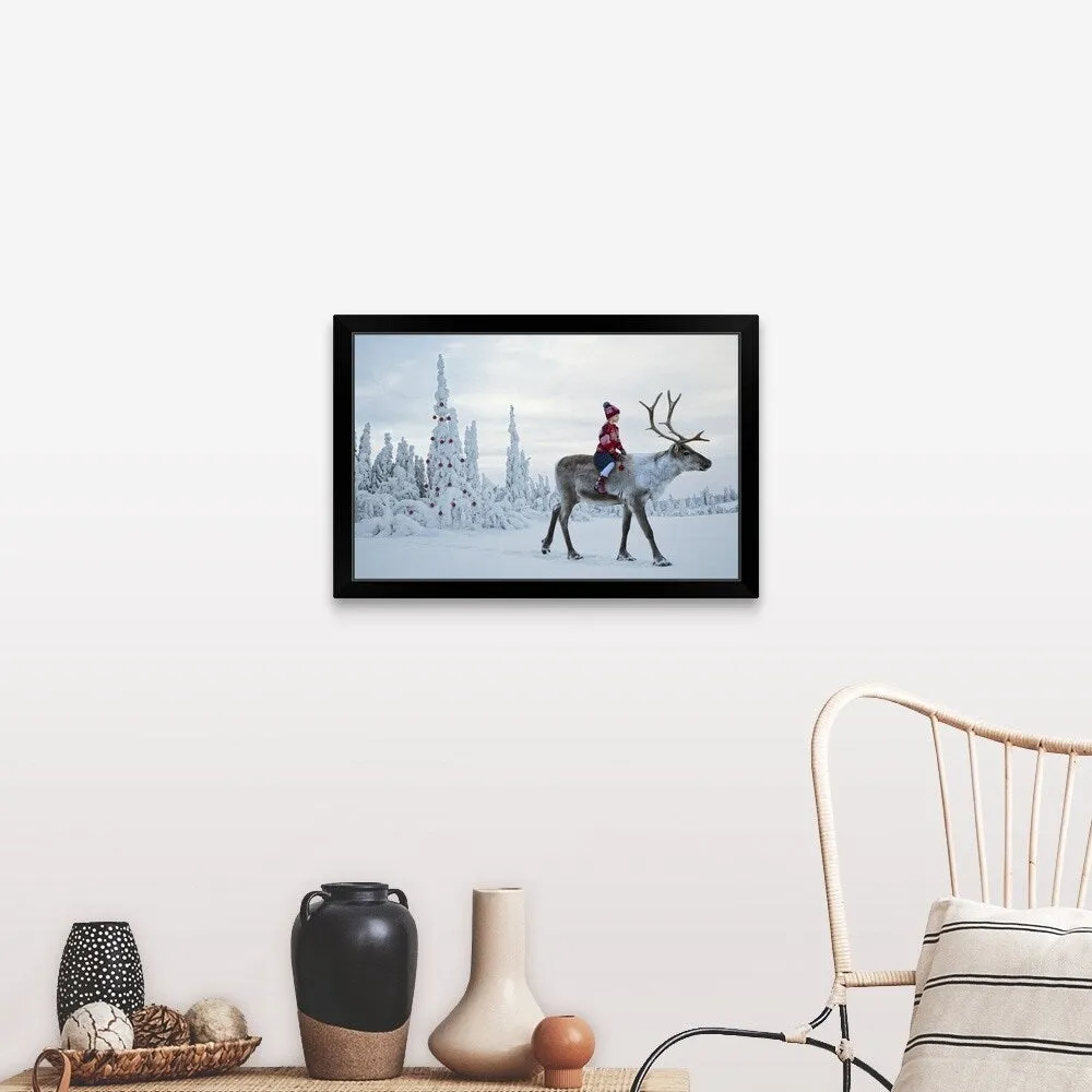 "A girl riding a reindeer through a winter forest" Black Framed Print